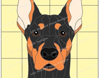 May include: A stained glass pattern of a Doberman Pinscher dog's head. The dog has black fur, brown eyes, and a tan muzzle. The background is a light yellow.