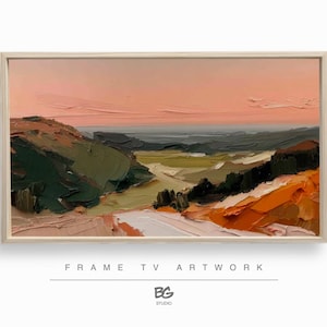 May include: Oil painting of a landscape with a light wood frame. The artwork depicts rolling hills in shades of green, orange, and white, under a pink and orange sky. The text "FRAME TV ARTWORK" is at the bottom.