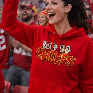 May include: A white ceramic mug with a black handle and the text "But First, Coffee" in a black, handwritten-style font. The mug is on a white surface.