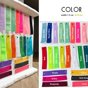 May include: A colour chart with 28 fabric swatches in various colours, including red, blue, green, yellow, orange, pink, and black. The swatches are labelled with their colour names and are arranged in rows. The chart is labelled "COLOR" and "width 1.5 cm (0.59 in)".