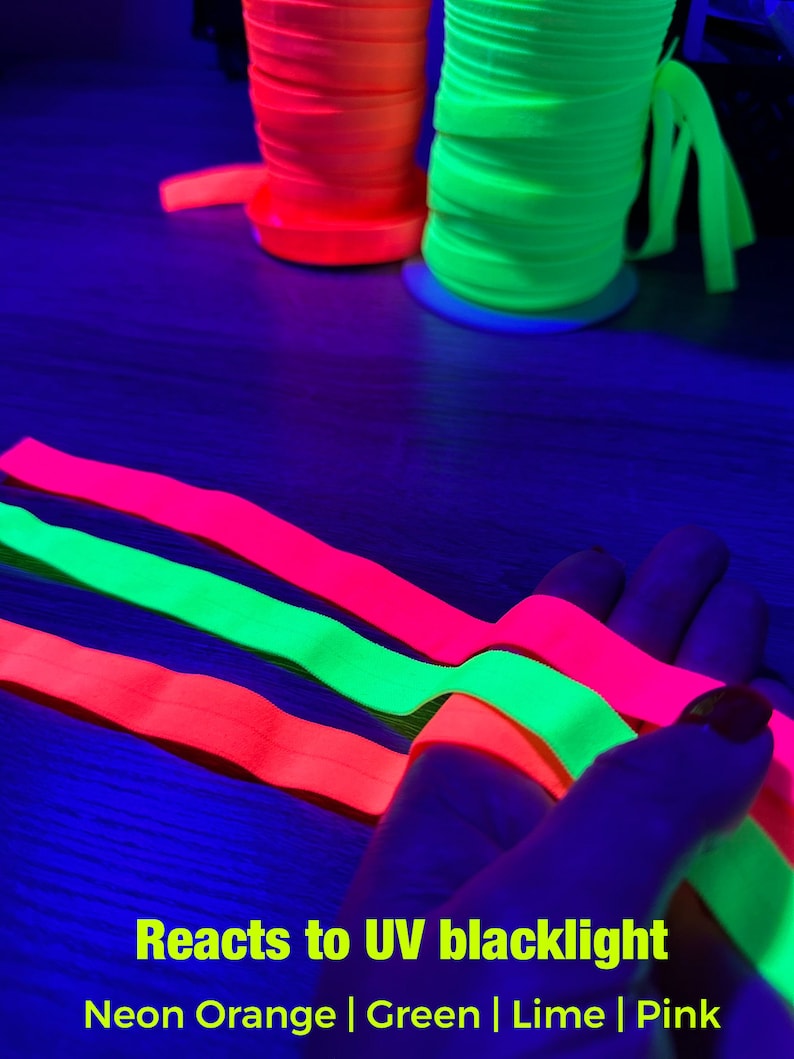 May include: Neon orange and green spools of ribbon are displayed, along with neon pink, green, and orange ribbons. The text "Reacts to UV blacklight" and color names are included.