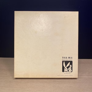May include: A vintage Trix-Mix Magic Kard Kapers box. The box is off-white with the words "TRIX-MIX MAGIC KARD KAPERS" in black. A black and white logo of a rabbit and playing cards is on the lower right corner. The box is made by Hoyle.