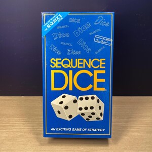 May include: A rectangular blue board game box titled Sequence Dice with large yellow text. The box features white dice with black pips, the text From the makers of the Sequence game, and a signature graphic. The bottom reads An exciting game of strategy.