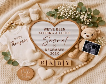 May include: A heart-shaped letter board with the text "WE'VE BEEN KEEPING A LITTLE SECRET" and "DECEMBER 202X". The image includes a baby onesie, ultrasound photo, teddy bear, baby booties, wooden blocks spelling "BABY", and decorative elements.