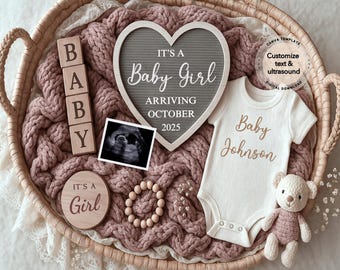 May include: A baby announcement arrangement in a woven basket. It includes a heart-shaped sign that reads "It's a Baby Girl Arriving October 2025", a baby onesie, wooden blocks spelling "BABY", and a small teddy bear.