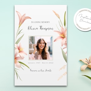 May include: A printable memorial card with a floral design featuring pink lilies and green leaves. The card includes a photo of a woman, the text "In Loving Memory Olivia Thompson", the dates "January 1947 - March 2022", and the phrase "Forever in Our Hearts".