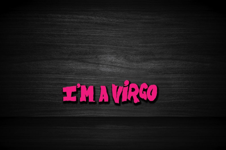 May include: Pink text on a black wood background that reads "I'M A VIRGO".
