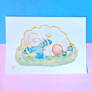 May include: A watercolour illustration on paper featuring a blue creature with striped ears and a large, fluffy white mane, curled up asleep on a patch of green grass. A small orange sphere sits beside the creature, and the text BUN is visible.
