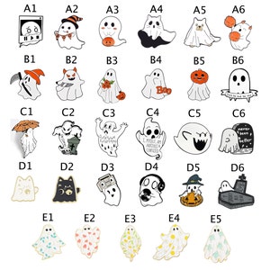 May include: Set of 30 enamel pins featuring various ghost designs. The pins are colorful and feature different Halloween themes, including a ghost with a pumpkin, a ghost with a boom, a ghost with a tombstone, and a ghost with a cat.