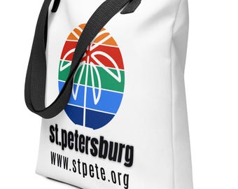 May include: White tote bag with black handles and a colourful palm tree logo. The text "st.petersburg www.stpete.org" is printed below the logo.