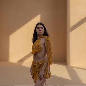 Gold macramé mini skirt and matching top with goddess necklace