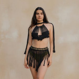 Black macramé goddess beach cover-up set layered over swimwear