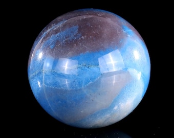 May include: A blue and white agate sphere with swirling patterns. The sphere is polished and has a smooth, glossy finish.