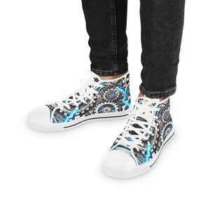May include: White high-top canvas sneakers with a blue and silver gear pattern. The sneakers have white laces and a white rubber sole.