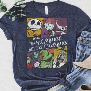 May include: A navy blue t-shirt with a vintage-style graphic of characters from the movie "The Nightmare Before Christmas". The graphic features Jack Skellington, Sally, and other characters from the film.