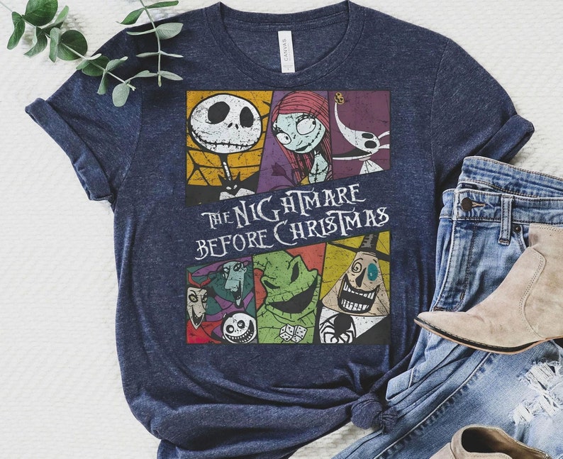 May include: A navy blue t-shirt with a vintage-style graphic of characters from the movie "The Nightmare Before Christmas". The graphic features Jack Skellington, Sally, and other characters from the film.