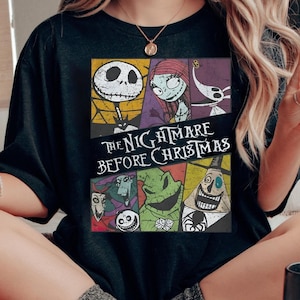 May include: Black t-shirt with a colorful graphic of characters from the movie "The Nightmare Before Christmas".