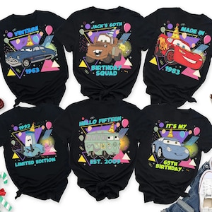 May include: Six black t-shirts with different designs featuring cartoon cars and the text "Vintage 1963", "Jack's 60th Birthday Squad", "Made in 1983", "1992 Limited Edition", "Hello Fifteen Est. 2009", and "It's My 65th Birthday".