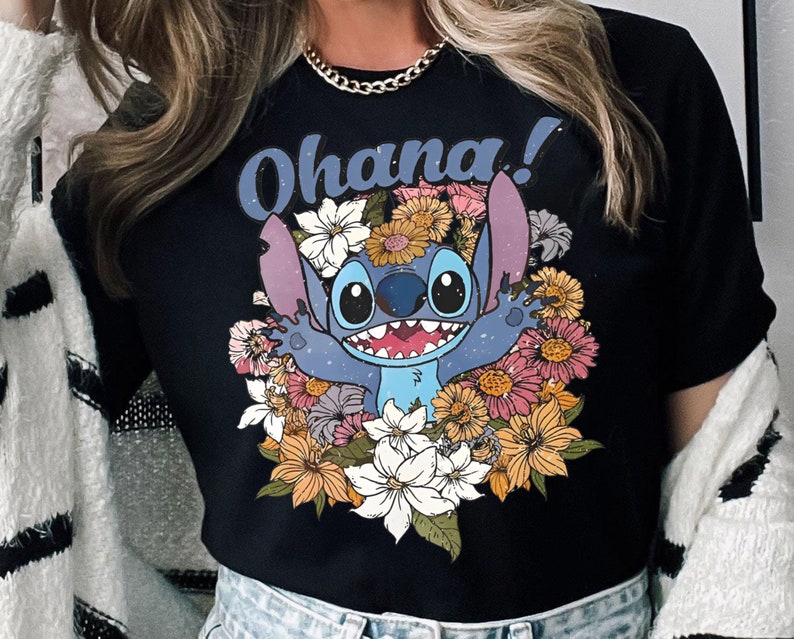 May include: Black t-shirt with a blue Stitch character from Lilo & Stitch surrounded by colorful flowers. The text "Ohana!" is printed above the character.