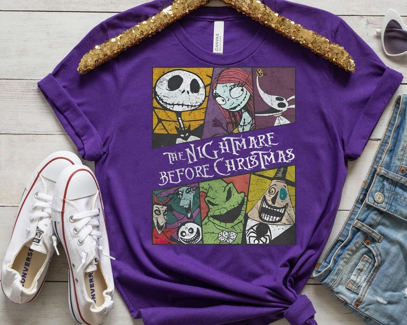 May include: Purple t-shirt with a graphic print of characters from the movie "The Nightmare Before Christmas". The text "The Nightmare Before Christmas" is printed in white on the shirt.