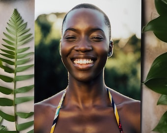 May include: A portrait of a smiling person with dark skin, wearing a colourful halter top. The background is blurred, with green foliage and soft, natural light. The image is framed with green leaves and other greenery.