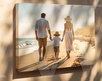 May include: A canvas print showing a family strolling along a beach at sunset. The image features a man, a woman, and a child, all wearing light-coloured clothes. The scene evokes a sense of family unity and peace.