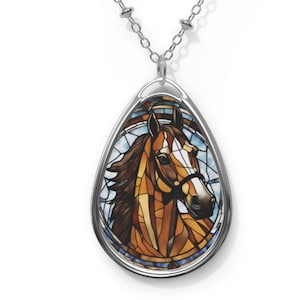 May include: A silver teardrop-shaped pendant necklace with a stained glass image of a brown horse's head.