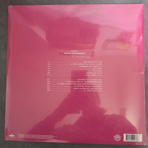 May include: A pink-covered vinyl record album, sealed in plastic. The album is titled "Digital Dreamscape" by Ayokay. The tracklist is printed in white, with song titles such as "Better With You" and "I'll Wait For You".
