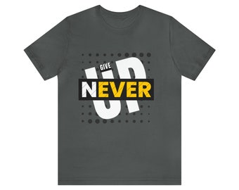 May include: A dark gray t-shirt with a white graphic that says "GIVE UP NEVER" in a bold, white font. The graphic is surrounded by a black and white polka dot pattern.