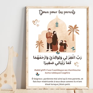 Puede incluir: Una impresión enmarcada con el texto "Doua pour les parents" y escritura árabe. La ilustración representa a una familia frente a una mezquita. La impresión está en un marco de madera.
