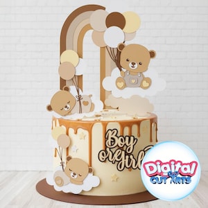 Könnte beinhalten: Ein Kuchen mit Karamelltropfen, mit einem Teddybären-Thema. Der Kuchen ist mit einem Regenbogen, Luftballons und Teddybären-Ausschnitten verziert. Die Worte "Boy or Girl" sind auf dem Kuchen zu sehen. Der Kuchen steht auf einem braunen Kuchenkarton.