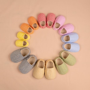 May include: A set of three ceramic mugs with a speckled, matte finish. The mugs are in shades of cream, light gray, and dark gray. Each mug has a simple, minimalist design, perfect for coffee or tea.