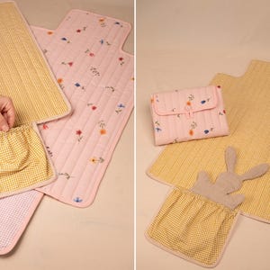 Puede incluir: Un conjunto de cambiadores y accesorios para beb&eacute;s. Los cambiadores presentan estampados de cuadros vichy rosas y amarillos, con detalles florales y de conejos. Incluye un cambiador, una funda y una peque&ntilde;a bolsa.