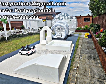May include: A white inflatable bubble ball, a white play structure with a slide and a ball pit, and two white toy cars in a garden setting. The text "Partynation" is visible on the play structure.