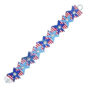 May include: A beaded bracelet with a repeating pattern of blue, red, and white stars. The bracelet is made with small seed beads and features white pearl accents.