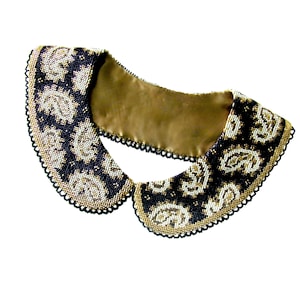 May include: A black and gold beaded collar with a paisley pattern. The collar is made of small beads and has a satin backing.