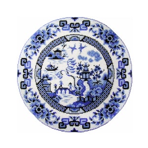 May include: A blue and white ceramic plate with a traditional Chinese design. The plate features a landscape scene with a pagoda, trees, and a river. The design is surrounded by a border of stylized flowers.
