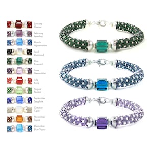 May include: A set of 12 beaded bracelets, each featuring a different coloured gemstone bead. The bracelets are made with silver-toned metal clasps and are arranged in a row from top to bottom. The gemstones are labelled with their corresponding birth month and stone name.