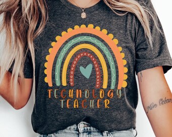 May include: A dark grey t-shirt with a rainbow design and the text "Technology Teacher".