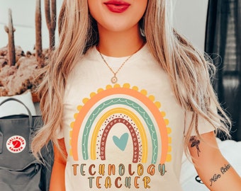 May include: A white t-shirt with a rainbow design and the text "Technology Teacher". The rainbow has a heart in the center and is surrounded by small hearts.