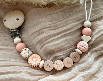Personalized pacifier chain with name for girls in pink with flower as a gift for birth or christening