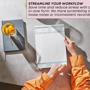 May include: A person holding a form with a grid layout, with the text "STREAMLINE YOUR WORKFLOW". A glass with a drink and a straw sits on a gray notebook. The person wears an orange long-sleeved shirt.