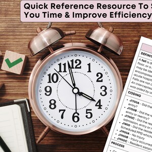 May include: A rose gold alarm clock with a white face and black numbers sits on a wooden surface. Beside the clock are wooden blocks with symbols and a notepad with a pencil. A document with text is also visible.