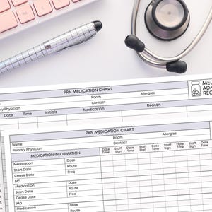 May include: A medication administration record chart with the text "PRN Medication Chart" and "Medication Administration Record". A stethoscope, a pen, and a pink keyboard are also visible.