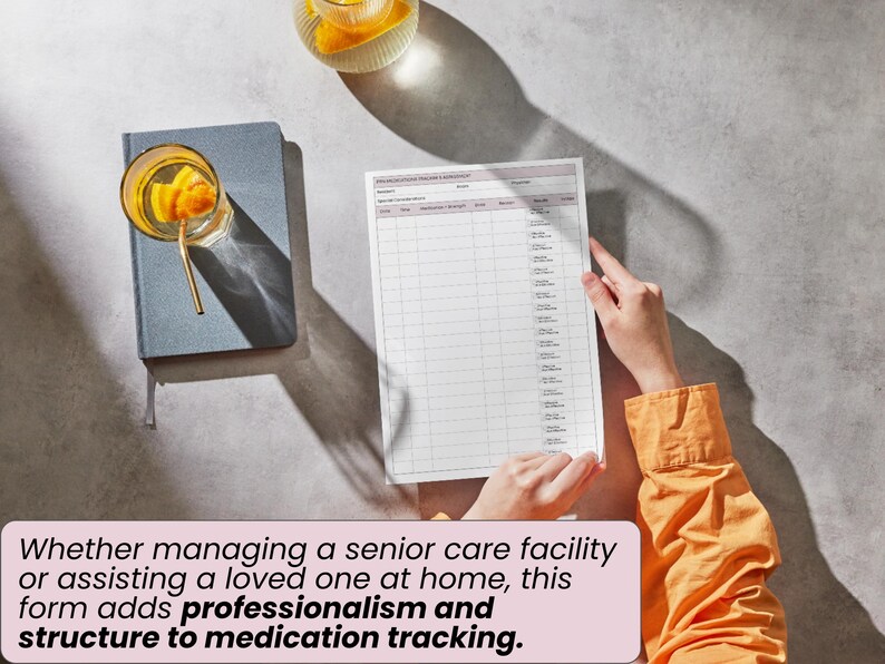 May include: A medication tracking form with a grid layout, held by a person wearing an orange shirt. A blue notebook and a glass of beverage with a gold straw are on the left. The form adds structure to medication tracking.