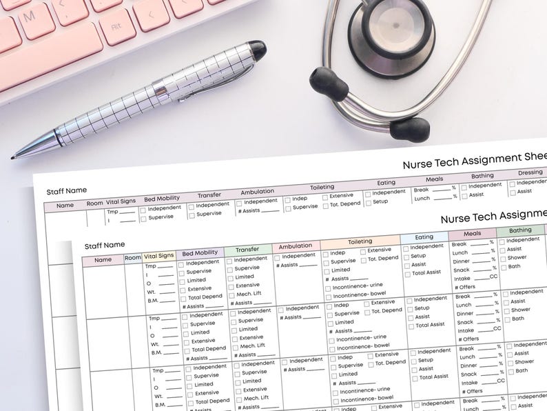 May include: A nurse tech assignment sheet with columns for vital signs, mobility, and eating. A silver pen and a stethoscope are on the white surface. A pink keyboard is in the upper left corner. The sheet has the text "Nurse Tech Assignment Sheet".