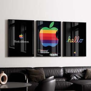 Könnte beinhalten: Drei schwarze gerahmte Poster mit einem Regenbogen-Apple-Logo, dem Text "Think different." und dem Text "hello".