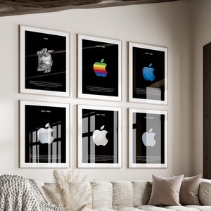 May include: Six framed black and white prints of the Apple logo, with different versions of the logo, on a white wall above a white couch with a white throw blanket and a white ottoman.