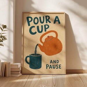 May include: A rectangular wall art print on a beige background featuring a dark teal teapot pouring liquid into a dark teal mug. The text reads "POUR A CUP" above the teapot and "AND PAUSE" below the mug in dark teal, bold, sans-serif lettering.