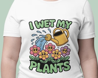 May include: White t-shirt with a colorful graphic. The design features a yellow watering can pouring water onto smiling flowers. The text "I WET MY PLANTS" is in green, adding a playful touch to this gardening-themed tee.